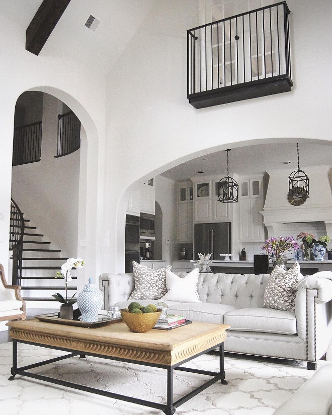 Living room vaulted ceiling opens to kitchen. Grey living room with vaulted ceiling and beams open to white kitchen trough an archway #Livingroom #vaultedceiling #livingroomopenstokitchen #Greylivingroom #ceilingbeams #whitekitchen #livingroomarchway Beautiful Homes of Instagram: classicstylehome