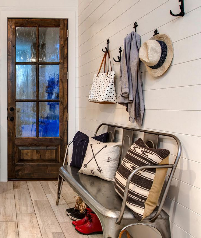 Mudroom Bench. This farmhouse mudroom features shiplap walls, anchor hooks and a metal Tolix bench. #TolixBench #Mudroom #MudroomBench #FarmhouseMudroom #Farmhousebench #Metalbench #shiplapwalls #anchorhooks Timberidge Custom Homes