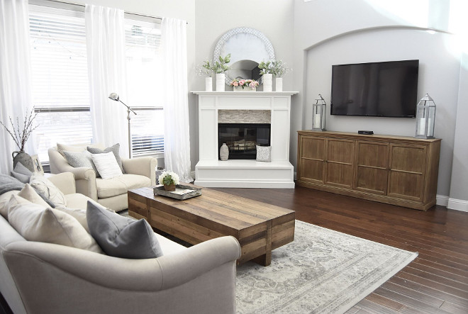 Neutral Family Room. Neutral family room with grey walls, dark hardwood flooring and white fireplace. Neutral Family Room #NeutralFamilyRoom Home Bunch's Beautiful Homes of Instagram Pillow Thought