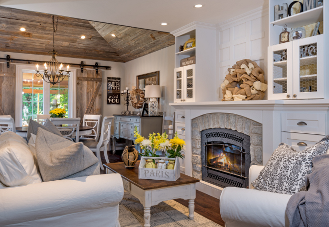 Open concept Farmhouse interiors. This entire space was completely renovated. In the living room, the contractor moved the gas-insert fireplace to make it fit into the layout in a pleasing way. He gave it a new stone veneer surround and crafted built-ins around it, which make it the focal point of the room. The homeowners asked him to fill the cabinet door frames with chicken wire to continue the rustic theme. Open concept Farmhouse interior ideas. Open concept Farmhouse interiors #OpenconceptFarmhouseinteriors #Openconcept #Farmhouseinteriors Hardcore Renos