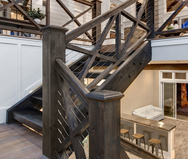 Staircase with Crossed wood balusters and cable railing. Stained Timber Staircase with Crossed wood balusters and cable railing. Staircase with Crossed wood balusters and cable railing. #Staircase #Crossedwoodrailings #balusters #Crossedwoodbalusters #cablerailing #StainedTimberStaircase #StainedTimber #TimberStaircaseTimberidge Custom Homes