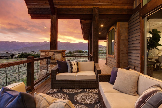 Timber Frame Home Balcony with timber railing. The patio doors open to this timber deck. All rooms from this side of the house open to this extensive outdoor space. Timber Frame Balcony with timber railing #TimberFrame #TimberFrameHome #timberrailing Timberidge Custom Homes