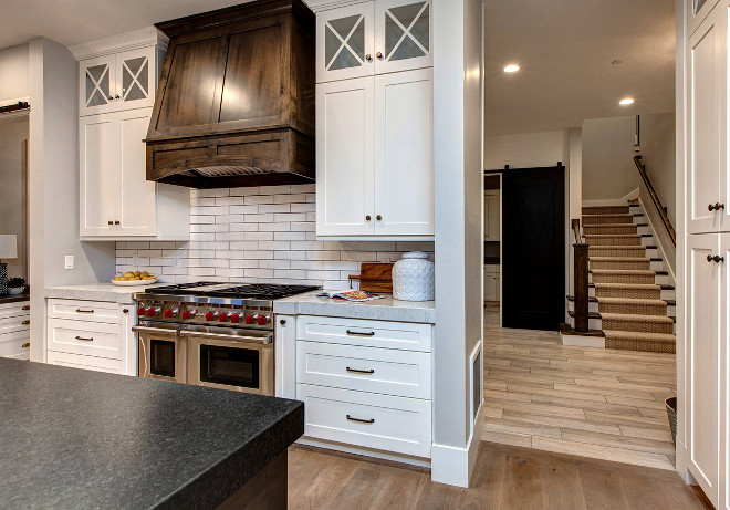 Two toned kitchen. White kitchen dark wood hood and island. #Twotonedkitchen #Whitekitchen #darkwood #hood #island