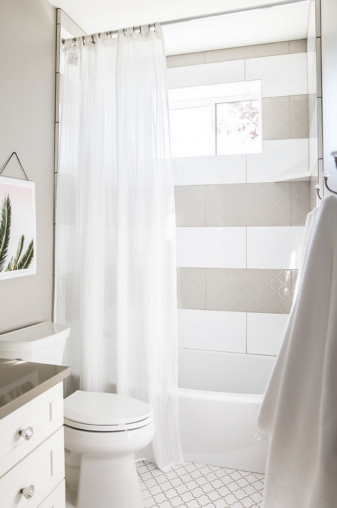 White and grey shower tile. White tile and grey Arabesque tiles are lined in stripes in this shower. #Arabesquetile #showertile #whiteandgreytile Timberidge Custom Homes