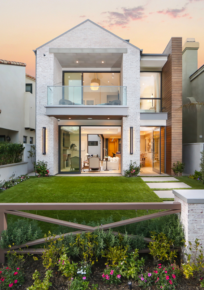 White washed brick exterior. The exterior of this home is comprised of white washed brick and stained t&g siding. The front pivot door and sliding doors create a home that is perfect for indoor-outdoor living. White washed brick exterior ideas. #Whitewashedbrick #Whitewashedbrickexterior #Whitewashedbrickexteriorideas Patterson Custom Homes