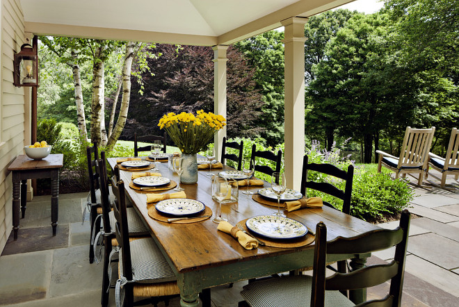 Farmhouse dining porch. Farmhouse dining porch with old farmhouse table. The farmhouse Dining Porch leads to a large bluestone terrace overlooking a lake. Distressed farmhouse table #Farmhouse #diningporch #farmhousetable