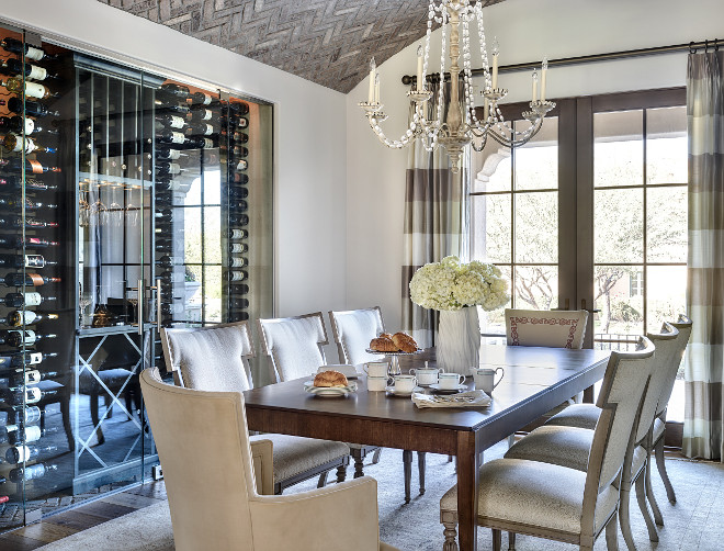 Glass enclosed wine cellar. Dining room with vaulted herringbone brick ceiling, French doors and custom glass enclosed wine cellar #Glassenclosedwinecellar #glasswinecellar Kim Scodro Interiors