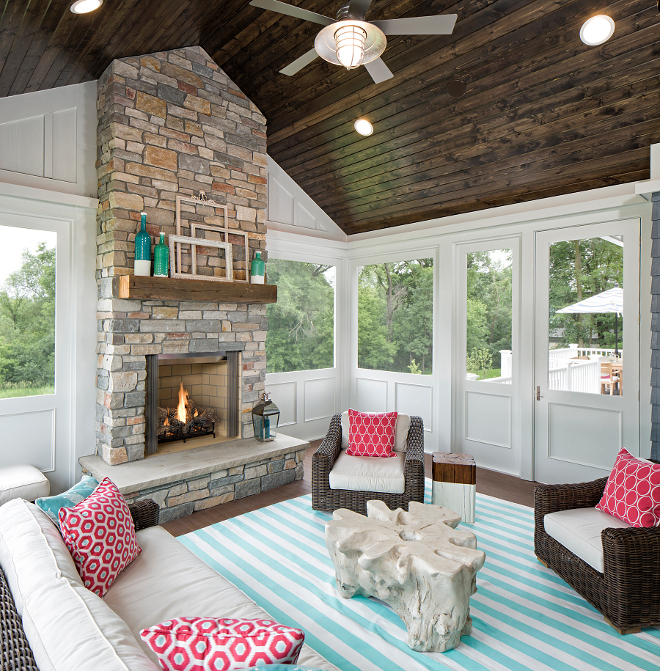 Screened in porch, This summery and cheerful screened-in porch features stained T&G ceiling boards, Cheerful and summery Screened in porch decor ideas, Screened in porch with stone fireplace #Screenedinporch Grace Hill Design
