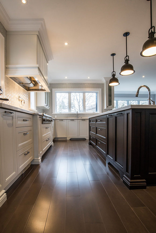 White kitchen with dark stained island and dark stained hardwood flooring. This is a good way to design a warm white kitchen. #whitekitchen #kitchen #darkisland #darkstainedisland #darkhardwood Hardcore Renos
