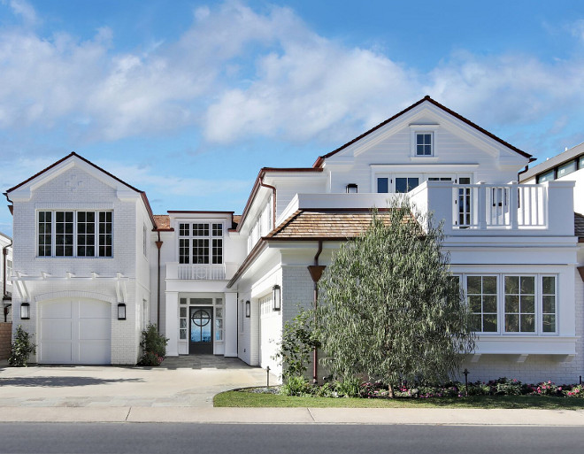 Beach House. The exterior of this beach house features painted white brick, custom railing and copper gutter. The front door paint color is Dunn Edwards DEW6350 Dark Engine and the exterior paint color is Whisper White by Dunn Edwards. California style beach house, California style beach house exterior design ideas #Californiastylebeachhouse #Californiabeachhouse Brandon Architects, Inc