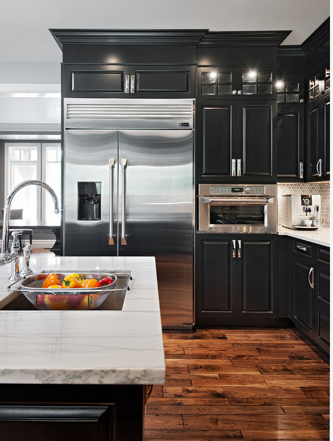 Ebony Kitchen Cabinets. Kitchen with ebony black cabinets and white marble countertop. Ebony is a sealer with black pigment in it applied in two coats and then top coated with a lacquer. #EbonyKitchen #EbonyCabinets #Kitchen #ebony #kitchen #blackcabinets #whitemarblecountertop Laurysen Kitchens Ltd