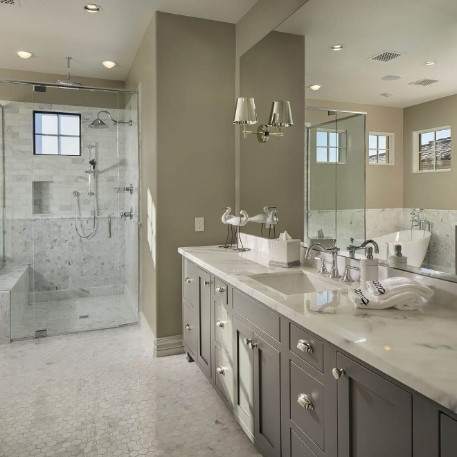 Greige Bathroom with grey vanity and curbless walk-in shower. Flooring is Hex Kacy Polished Marble. Light Greige Bathroom with grey vanity and curbless walk-in shower. Greige Bathroom. Curbless Shower #GreigeBathroom #greyvanity #curblesswalkinshowe #curblessshower #walkinshower #Flooring #Hextile #KacyPolishedMarble #kacymarble Luster Custom Homes & Remodeling