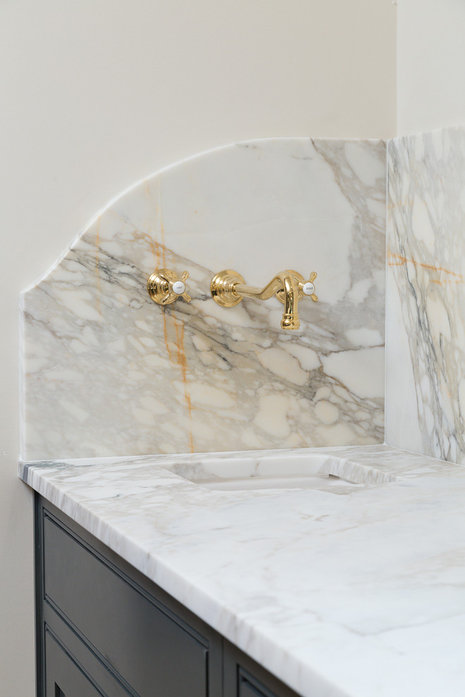 Marble slab countertop and Marble slab backsplash with wall-mounted brass faucet Willow Homes