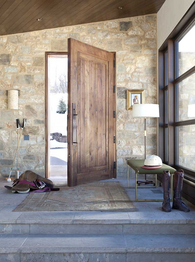 Rustic Farmhouse Foyer with stone wall and rustic stone flooring, large windows and wood paneling ceiling. #Foyer #farmhouse #rusticinteriors #rusticfarmhouse #rusticfoyer #RusticFarmhouseFoyer #stonewall #rusticstone #rusticflooring #largewindows #woodpaneling #wood Andrea Lawrence Wood Interior Designceiling
