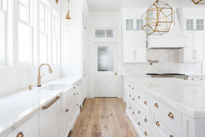 White Farmhouse Kitchen. White Farmhouse Kitchen. This White Farmhouse Kitchen combines classic elements like the white marble countertop and backsplash with farmhouse trends such as shiplap paneling, cross hatch pantry door, tongue and groove ceiling and white oak floors #farmhousekitchen #farmhousekitchens #whitefarmhousekicthen #kitchen #shiplap #tongueandgroove whiteoak #whiteoakfloor #flooring #hardwoodflooring Artisan Signature Homes. Grey House Design