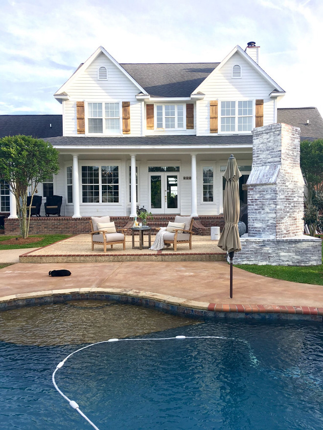 Back View of Traditional Farmhouse with pool and outdoor brick fireplace. The exterior paint color is Benjamin Moore White. #houseBackView #TraditionalFarmhouse #pool #outdoorbrickfireplace Beautiful Homes of Instagram @cindimc.ivoryhome