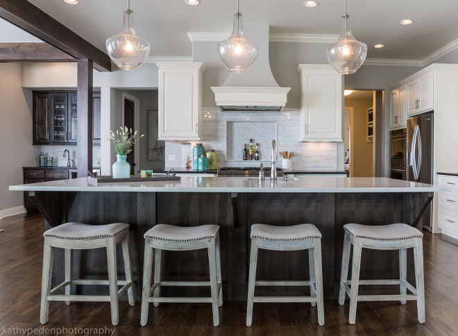 Benjamin Moore Revere Pewter Kitchen. This kitchen is timeless with white cabinetry, dark quartz countertops and marble backsplash. Wall paint color is Revere Pewter by Benjamin Moore #BenjaminMooreReverePewter #Kitchen #ReverePewterbyBenjaminMoore Restyle Design, LLC.