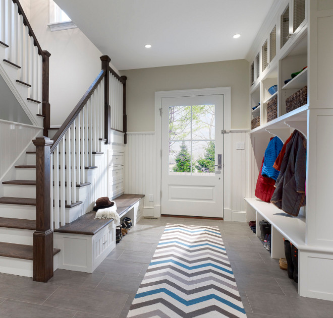 Mudroom Storage. Custom cabinetry and special storage bench built into the stairway make for an unusually efficient and beautiful mudroom #mudroom #mudroomstorage Knight Architects LLC