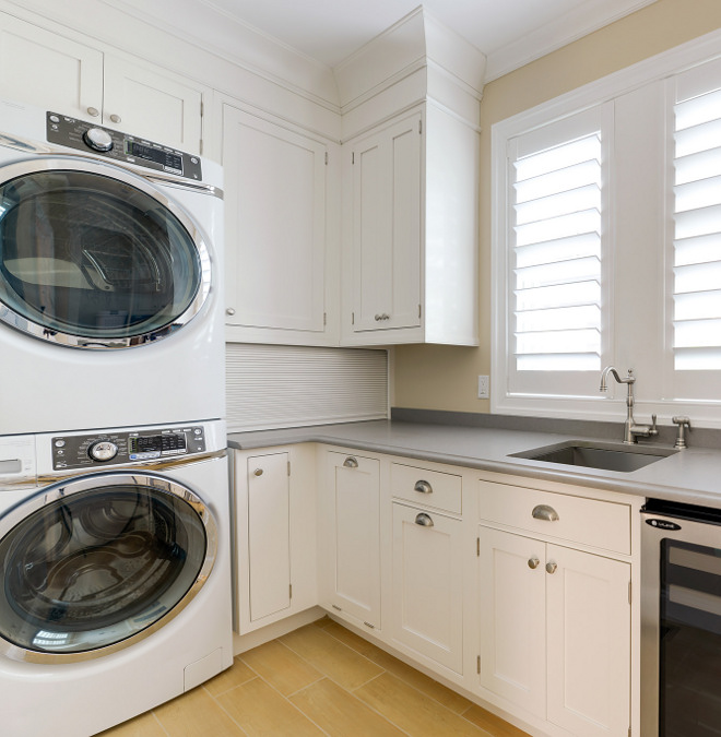 Recessed-panel laundry room cabinet. Recessed-panel cabinetry, quartz countertop and stacked washer and dryer makes the most of this space. Recessed-panel laundry room cabinet and grey quartz countertop #Recessedpanellaundryroomcabinet #Recessedpanelcabinet #laundryroom Echelon Custom Homes