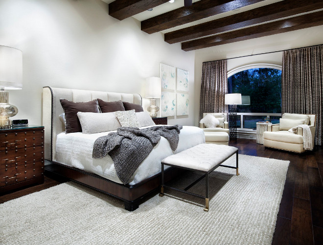 Transitional Bedroom with wood beams. Transitional Bedroom with wood ceiling beams and dark hardwood floors #TransitionalBedroom #bedroom #woodbeams JAUREGUI Architecture Interiors Construction