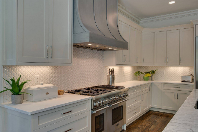White kitchen with mini tile backsplash and curved metal hood. White kitchen with mini tile backsplash and curved metal hood #Whitekitchen #minitilebacksplash #backsplash #curvedmetalhood #metalhood Tammy Coulter Design - Grandfather Homes