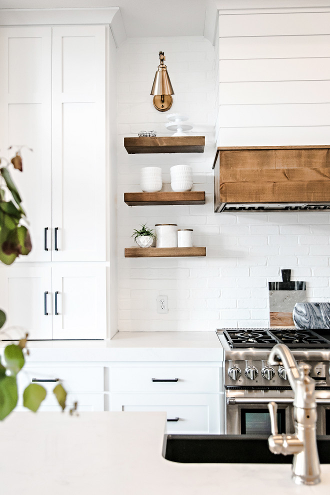 Wood Shelves. Kitchen Floating Wood Shelves, Painted Brick Backsplash, Brass Sconce and Shiplap Hood. Floating Wood Shelves. Kitchen Floating Wood Shelves. Kitchen Floating Wood Shelves. Kitchen Floating Wood Shelves #WoodShelves #KitchenShelves #FloatingWoodShelves #FloatingShelves #PaintedBrickBacksplash #BrassSconce #ShiplapHood Sita Montgomery Interiors.