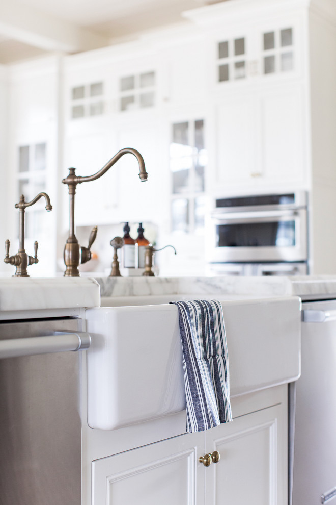 Aged Brass Kitchen Faucet. Unlacquered brass faucet. A farmhouse sink with aged brass faucet is flanked by two stainless steel dishwashers. Brass Faucet. Aged Brass Kitchen Faucet and farmhouse sink. Aged Brass Kitchen Faucet #AgedBrassKitchenFaucet #KitchenFaucet #brassfaucet #Faucet #AgedBrassFaucet #farmhousesink Pink Peonies Rachel Parcell's Kitchen Pink Peonies Rachel Parcell's Kitchen