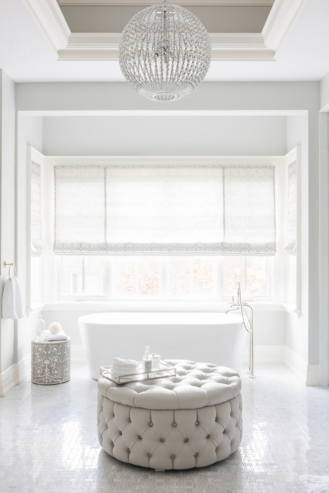 Classic Bathroom Design. Classic Bathroom Design Ideas. Classic bathroom design with mosaic marble floors and a sleek freestanding tub. A large round tufted ottoman brings texture and warmth to this master bath. Classic Bathroom Design. Classic Bathroom Design #ClassicBathroomDesign #ClassicBathroomDesignIdeas Tara Fingold Interiors