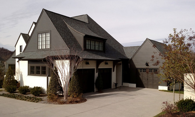 Black Garage Doors. Farmhouse with Black Garage Doors. This farmhouse exterior features black garage doors and black windows by Pella. Black Garage Door Ideas. Black Garage Door Paint Color #BlackGarageDoors #FarmhouseBlackGarageDoors #FarmhouseGarageDoors #BlackGarageDoorIdeas #BlackGarageDoorPaintColor #GarageDoorPaintColor C Kevin Coffey Dwellings