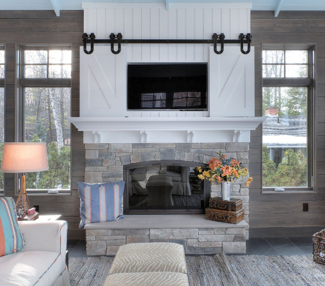 Sliding Barn Door TV Cover. This farmhouse-style fireplace features a sliding barn door TV cover. Farmhouse Sliding Barn Door TV Cover. Fireplace Sliding Barn Door TV Cover. #SlidingBarnDoorTVCover #FarmhouseSlidingBarnDoorTVCover #FireplaceSlidingTVBarnDoor #TVCover MAC Custom Homes