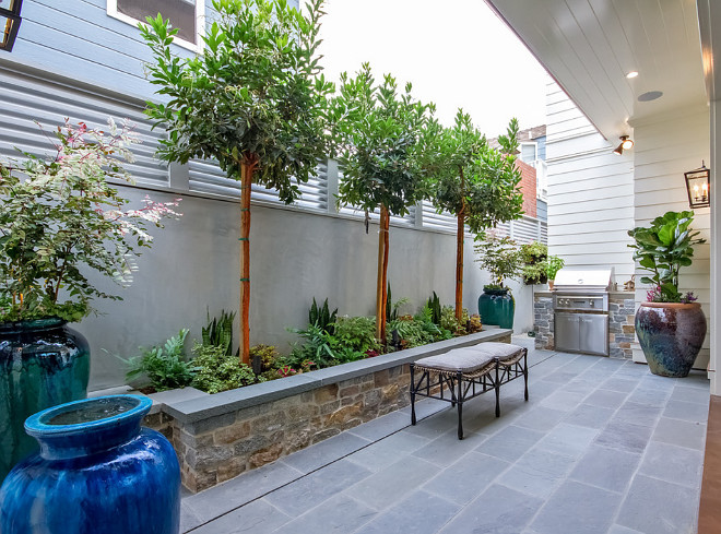 Small Backyard Patio with outdoor kitchen and large planters. #smallbackyard #smalloutdoorkitchen #outdoorkitchen Brandon Architects, Inc.