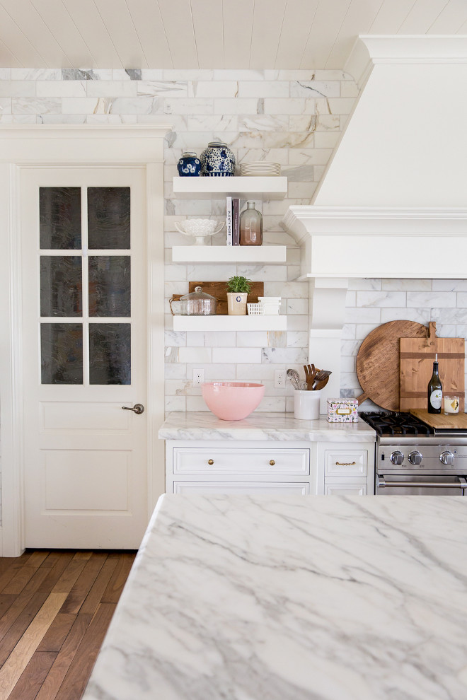 White Kitchen with lots of white marble - white marble countertops and white marble backsplash tile. This white kitchen is all about white marble - white marble countertops and white marble backsplash tile. Also, notice the pantry door on the left. White Kitchen with lots of white marble - white marble countertops and white marble backsplash tile #WhiteKitchen #kitchen #whitemarble #whitemarblecountertop #whitemarblebacksplashtile #marblebacksplashtile Pink Peonies Rachel Parcell's Kitchen