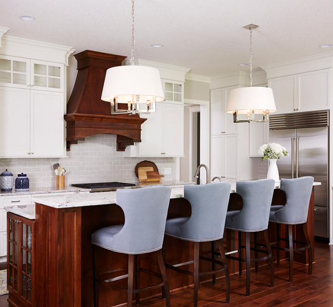 White kitchen with walnut hood and walnut island. This classic white kitchen combines stain and enameled cabinetry. White kitchen with walnut hood and walnut island ideas. White kitchen with walnut hood and walnut island color #Whitekitchen #walnuthood #walnutisland #walnutkitchenisland Bria Hammel Interiors