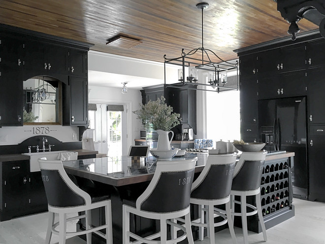 Black Farmhouse Kitchen. Black Farmhouse Kitchen. I designed the cabinetry to give a sense of history while also bringing a bit of drama. Curved elements inspired by the hoop top front door are repeated throughout this space. Some examples of this are curvy corbels, backplates for knobs, globe like pendants and a half moon arch over the sink. Black Farmhouse Kitchen #BlackFarmhouseKitchen #FarmhouseKitchen #Blackkitchen Part of the joy living in an old home brings is the connection to living history. Home Bunch's Beautiful Homes of Instagram Cynthia Weber Design @Cynthia_Weber_Design 