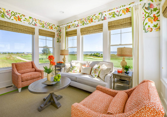 Cheerful sunroom with ocean view. Featuring wainscoting and a floral wallpaper by Thibaut, this sunroom is all about being happy and enjoying that ocean view! Wallpaper above wainscoting is Thibaut Janta Bazaar in Brights. Cheerful sunroom with ocean view. Cheerful sunroom with ocean view Cheerful sunroom with ocean view #Cheerful #sunroom #oceanview Echelon Interiors