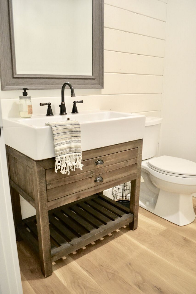Famrhouse Bathroom. Our guest bathroom on the main level is definitely has some rustic, farmhouse charm with a shiplap wall and wood trough sink. #farmhousebathroom #farmhouse #bathroom Home Bunch's Beautiful Homes of Instagram @sweetthreadsco