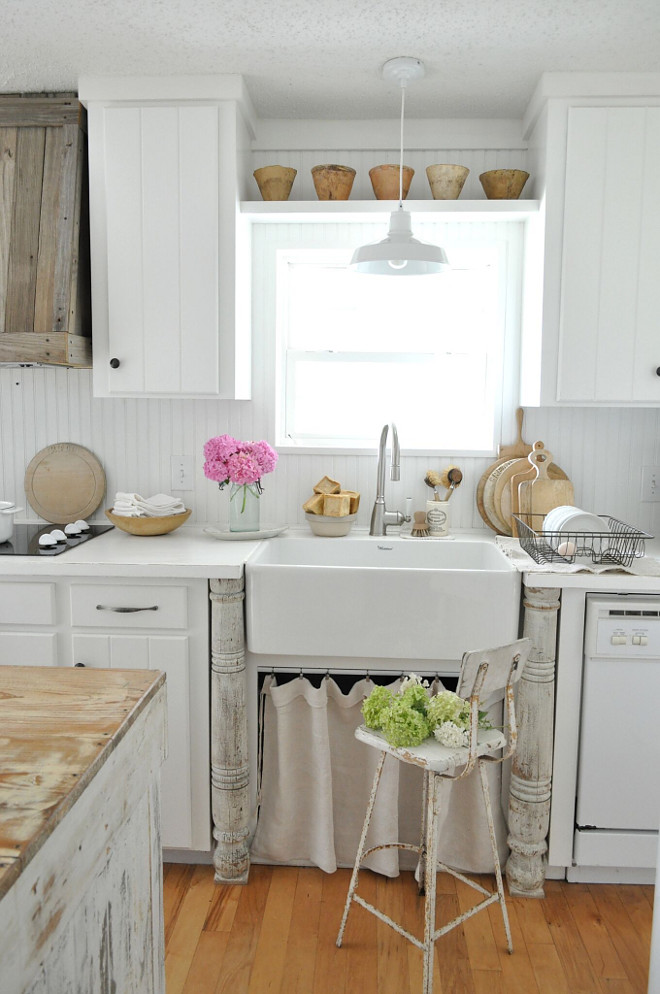 Farmhouse kitchen with skirted farmhouse sink. We purchased the vintage wooden posts that anchor the sink, from a local antique shop. White Farmhouse kitchen with skirted farmhouse sink. Farmhouse kitchen with skirted farmhouse sink #Farmhousekitchen #skirtedsink #farmhousesink Home Bunch's Beautiful Homes of Instagram @becky.cunningham.home