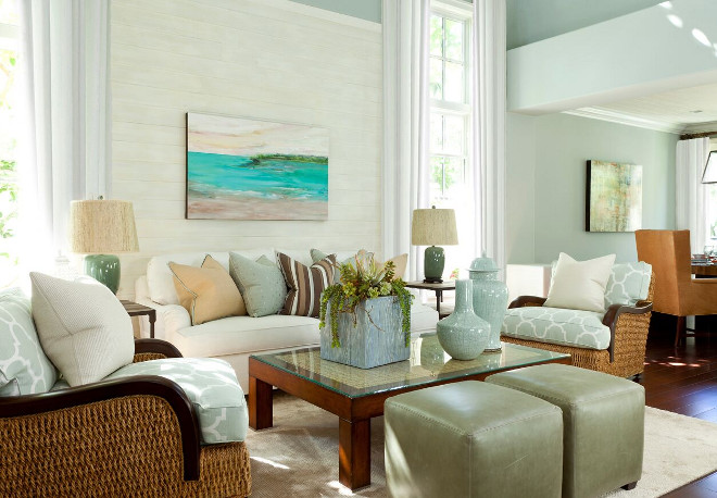 In the great room, because of the high ceilings, we added V Groove horizontal paneling and finished it in driftwood white to add a beachy, worn-over-time touch which made the room feel cozier. Barclay Butera