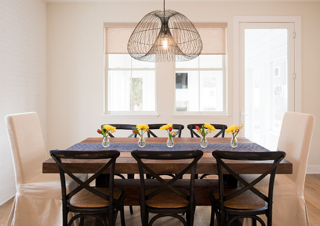 Modern Farmhouse Dining Area. Simple and skeek farmhouse dining area. I love the uncluttered feel of this dining area. This is especially good if you have small children - less clutter means more space for them to run around without getting hurt! Light fixture is Crate and Barrel #diningarea #modernfarmhouses Refined Custom Homes