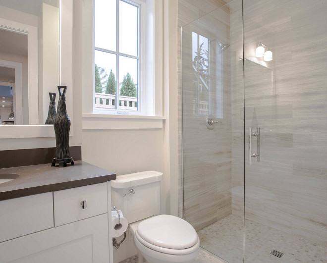 Neutral Bathroom Tile Ideas. The countertop is Pentals' Coastal Gray quartz, and the shower tile is Travertine Silver. Neutral Bathroom Tile Ideas #NeutralBathroomTile #NeutralBathroomTileIdeas Calista Interiors
