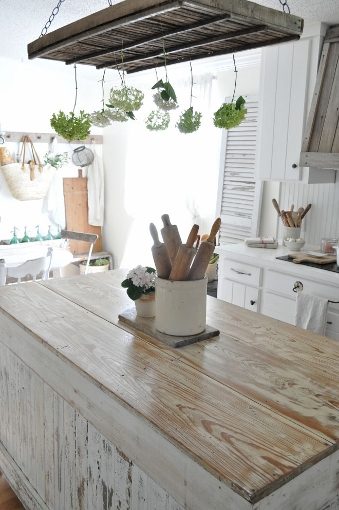 Shabby Chic Farmhouse Kitchen with distressed white island. The island is built from reclaimed wood. Shabby Chic Farmhouse Kitchen with distressed and whitewashed Kitchen island Home Bunch's Beautiful Homes of Instagram @becky.cunningham.home