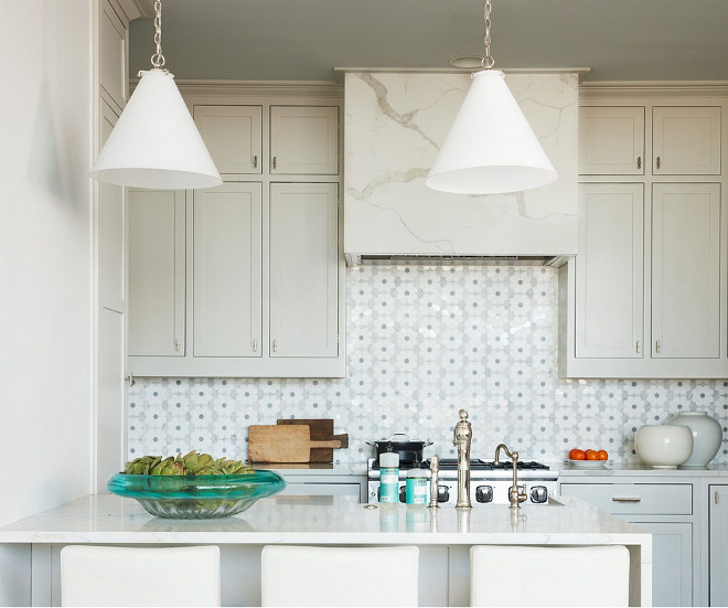 Small Kitchen. Small Kitchen Paint Color. The flower patterned backsplash tile is from New Ravenna and the lighting is by Visual Comfort. Hood features a marble slab. Small Kitchen Countertop. Small Kitchen Lighting. Small Kitchen island. Small Kitchen Design #SmallKitchen Andrew Howard Interior Design