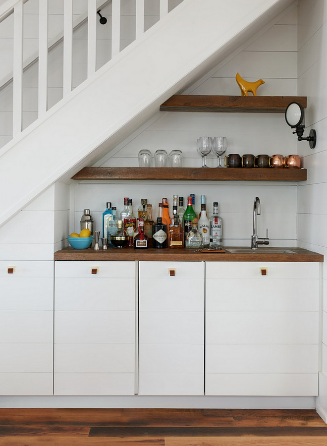 Wet Bar under stairs. Wet Bar under staircase. Built in wet bar under the stairs with floating shelves and shiplap cabinets and shiplap paneling. Wet Bar under the stairs #WetBarunderstairs #WetBar #Barunderstaircase Jennifer Worts Design Inc