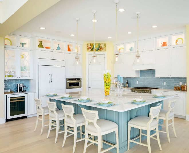 White Kitchen with Blue Backsplash Tile. This cheerful kitchen features crisp white cabinets, a blue island and a great layout! Notice the wet bar on the left. Coastal White Kitchen with Blue Backsplash Tile. White Kitchen with Blue Backsplash Tile Ideas #WhiteKitchenwithBlueBacksplash #WhiteKitchenwithBlueBacksplashTile Echelon Interiors