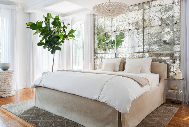 Bedroom Mirror. Bedroom antique mirror behind bed. The designer created this created this beautiful, reflective feature by mounting 9 of the same style of mirror, butted up against each other, to the wall behind the bed. #mirror #bedroom #bedrooms Toronto Interior Design Group | Yanic Simard