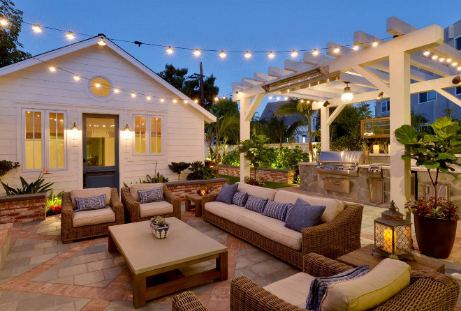 Farmhouse Patio with outdoor kitchen under pergola, seating area and string lighting. Patio flooring is red brick and slate tile #patio Torrey Pines Landscape Co. Inc