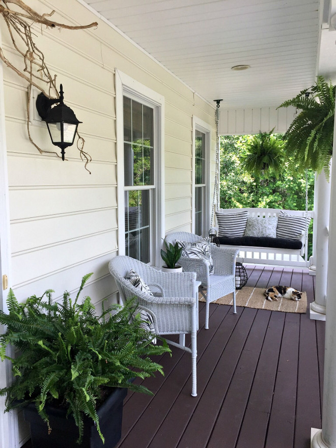 Front Porch. Front Porch stain is James T Davis solid stain in the color Tree Bark. The swing is from Hayneedle and the wicker conversation chairs are from Pier 1. Rugs are from Target. #frontporch #porch Beautiful Homes of Instagram @middlesisterdesign - Home Bunch