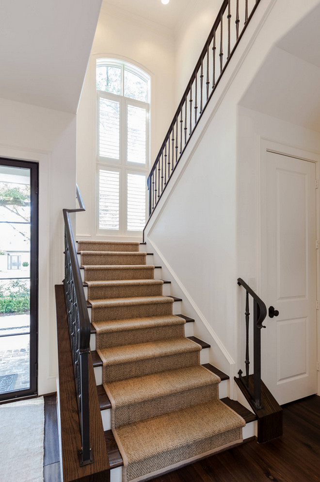 Stair runner. Sisal stair runner. Stair features sisal runner, dark Oak hardwood floors and metal railing. #stairRunner #runner #sisalrunner #metalrailing #darkhardwood