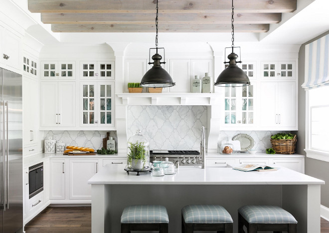 White farmhouse kitchen with bleached ceiling beams. White farmhouse kitchen with bleached ceiling beams. This white farmhouse kitchen features a pale gray kitchen and bleached ceiling beams. Beams are rough cedar and then white/grey washed. Backsplash tile is from Louisville tile. White farmhouse kitchen with bleached ceiling beams #Whitefarmhousekitchen #bleachedceilingbeams