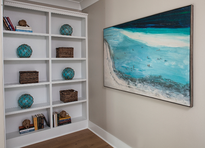 Bookcase Coastal Decor and Coastal Art. Wall Paint color is Benjamin Moore HC-172 Revere Pewter and bookcases are painted in Sherwin Williams Pure White. Lisa Furey - Barefoot Interiors